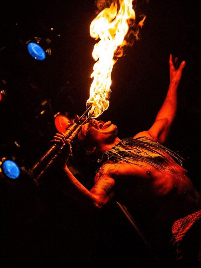 A fire performer on the Island Breeze Luau stage